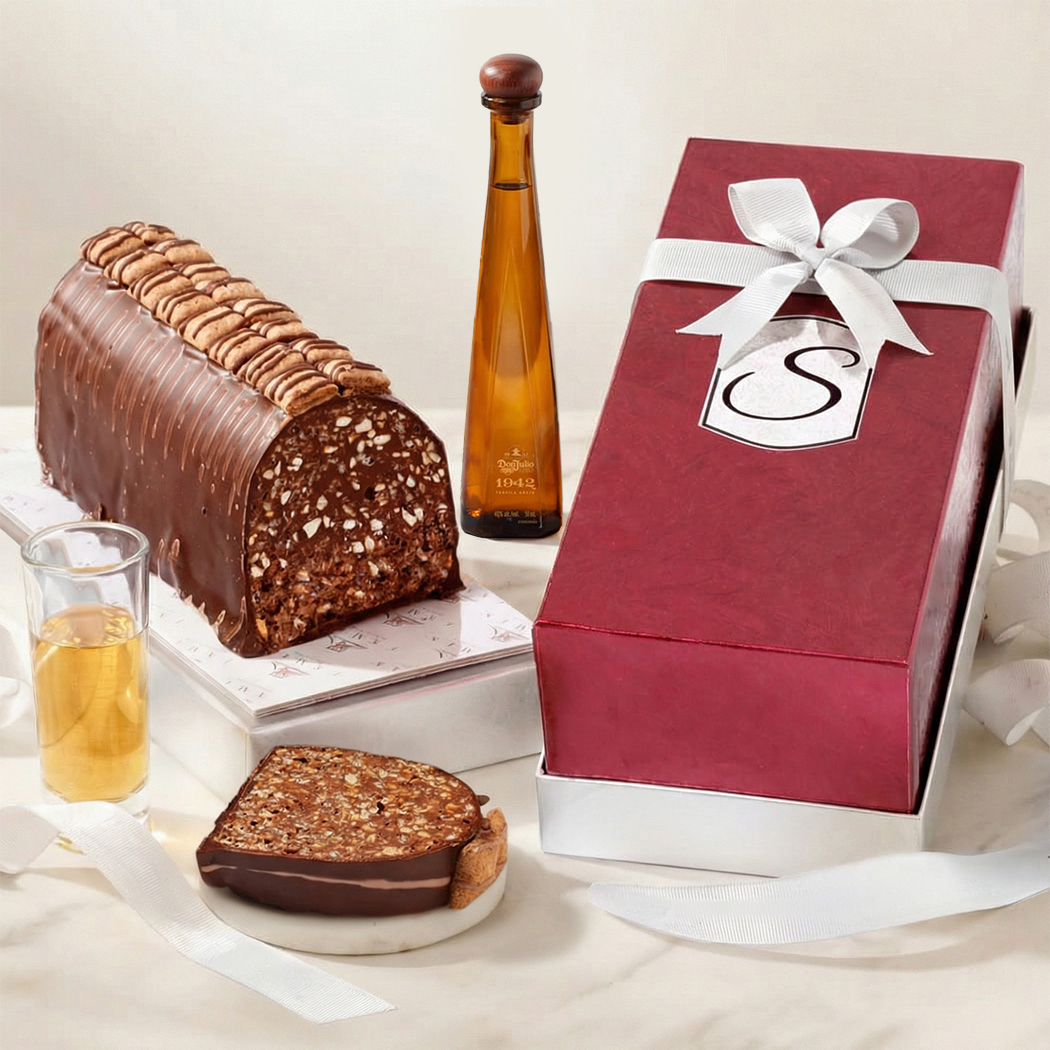 Elegant red box and bow filled with chocolate cake to share and glass tequila bottle
